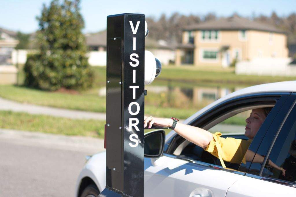 A woman in a car pulling up to a Virtual Gate Guard